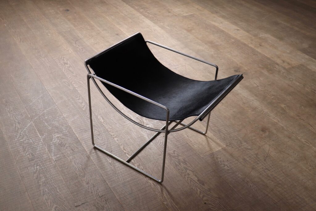 French modernist Filo lounge chairs by Odile Mir with black pony seats and tubular chrome frames.
