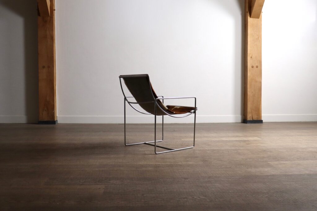 Rear view of the Odile Mir Filo Lounge Chair Model 203 with exposed chrome construction.