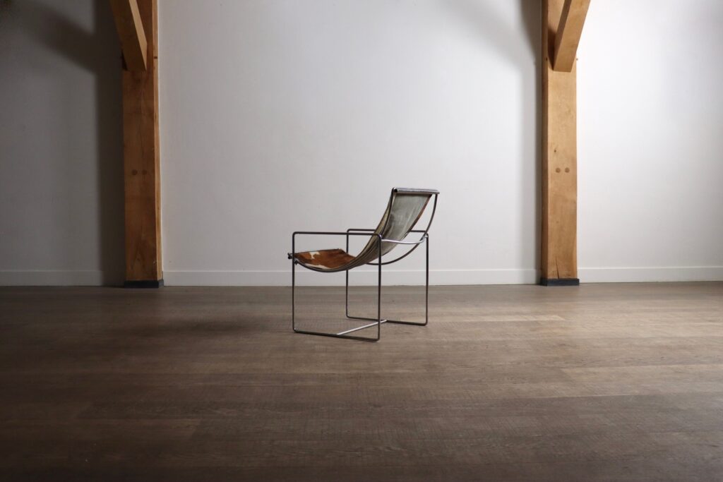 Rear view of the Odile Mir Filo Lounge Chair Model 203 with exposed chrome construction.
