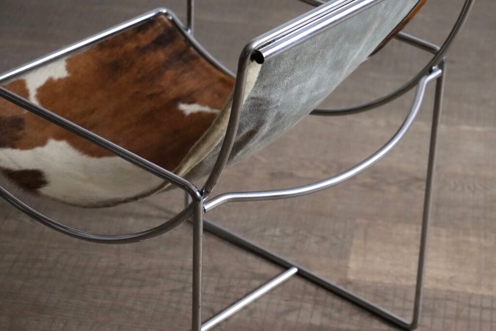 Original cowskin upholstery on the rare Filo Model 203 lounge chair by Odile Mir.