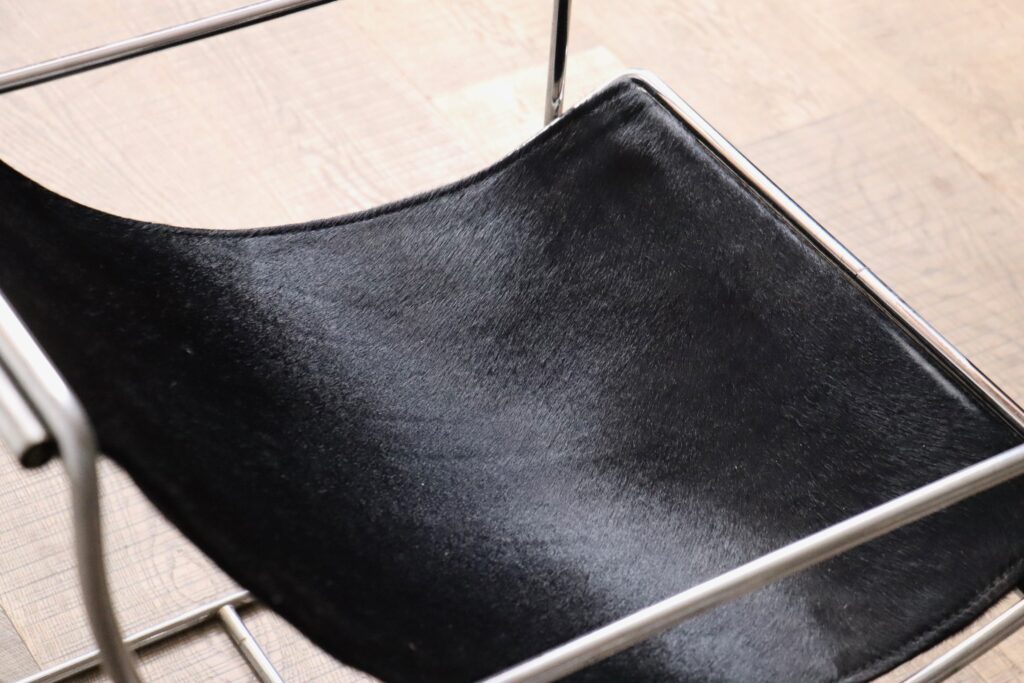 Black pony upholstery on the Odile Mir Filo lounge chairs designed for Prisunic in 1971.