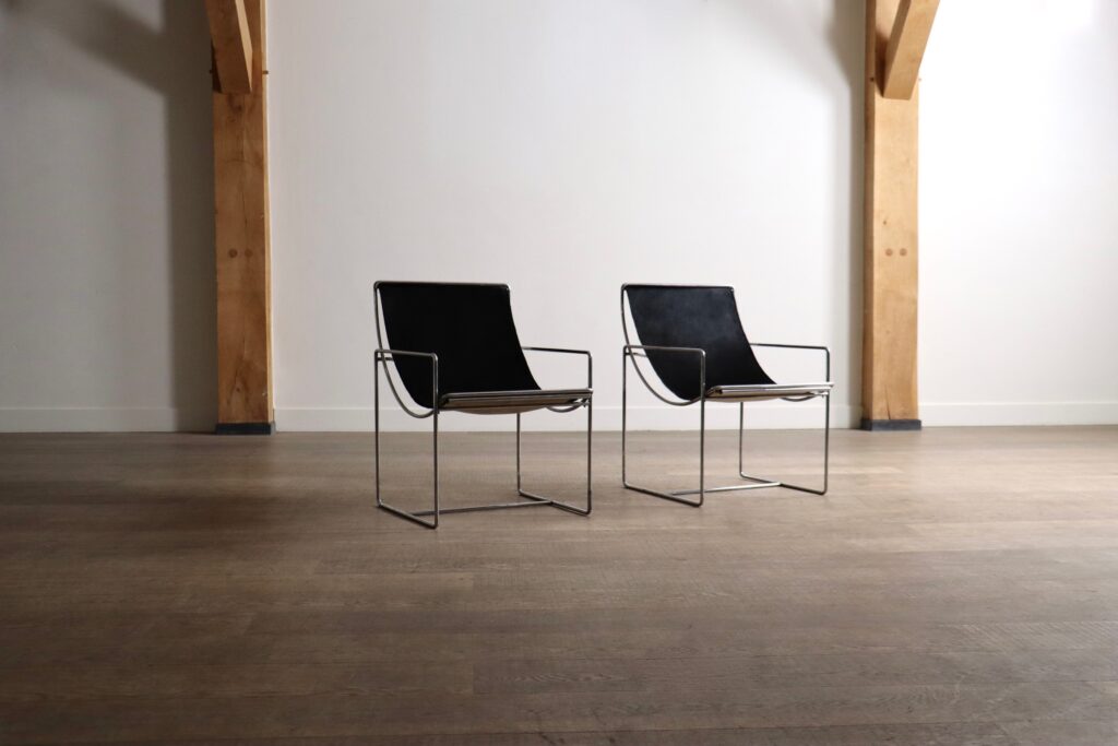 Pair of Odile Mir Filo Model 203 lounge chairs for Prisunic, France 1971, with chrome frames and black pony upholstery.