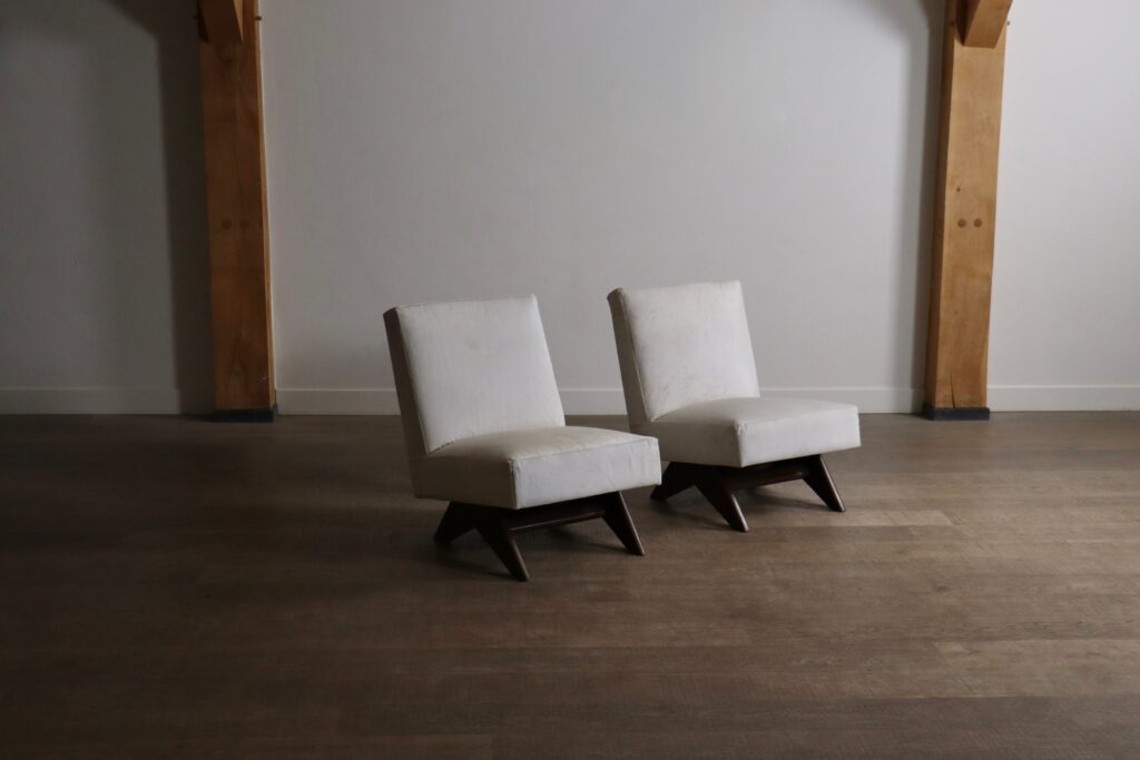 Angled view of Pierre Jeanneret PJ-SI-36-A chairs with low compass-style legs
