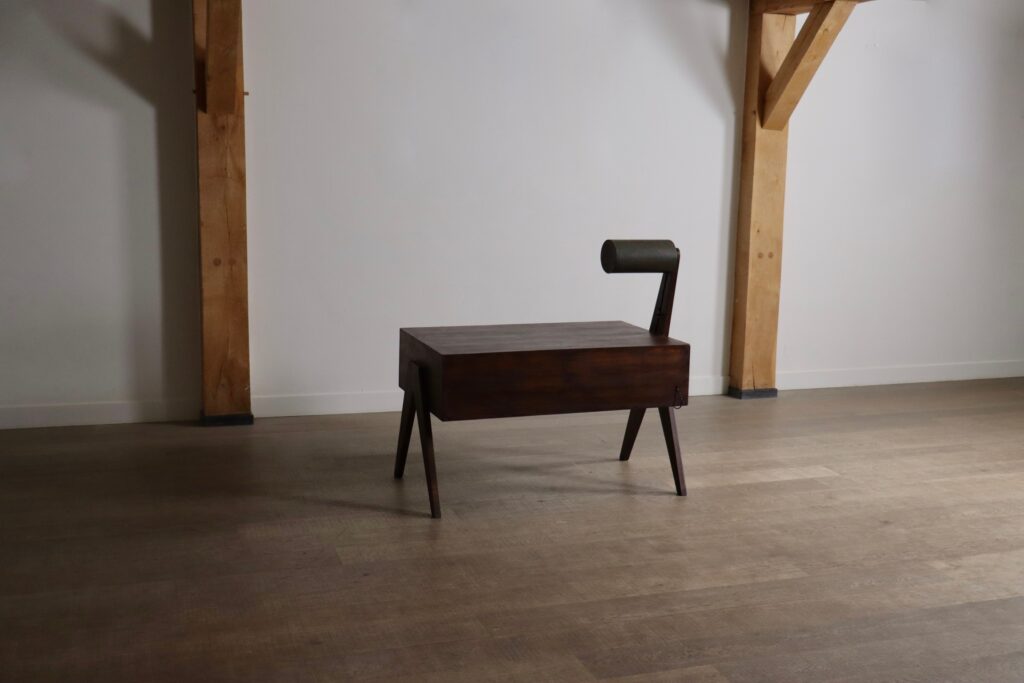 Rear angled view of a Pierre Jeanneret office desk with lamp