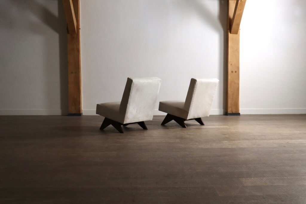 Rear view of Pierre Jeanneret PJ-SI-36-A chairs with tilted upholstered backrests