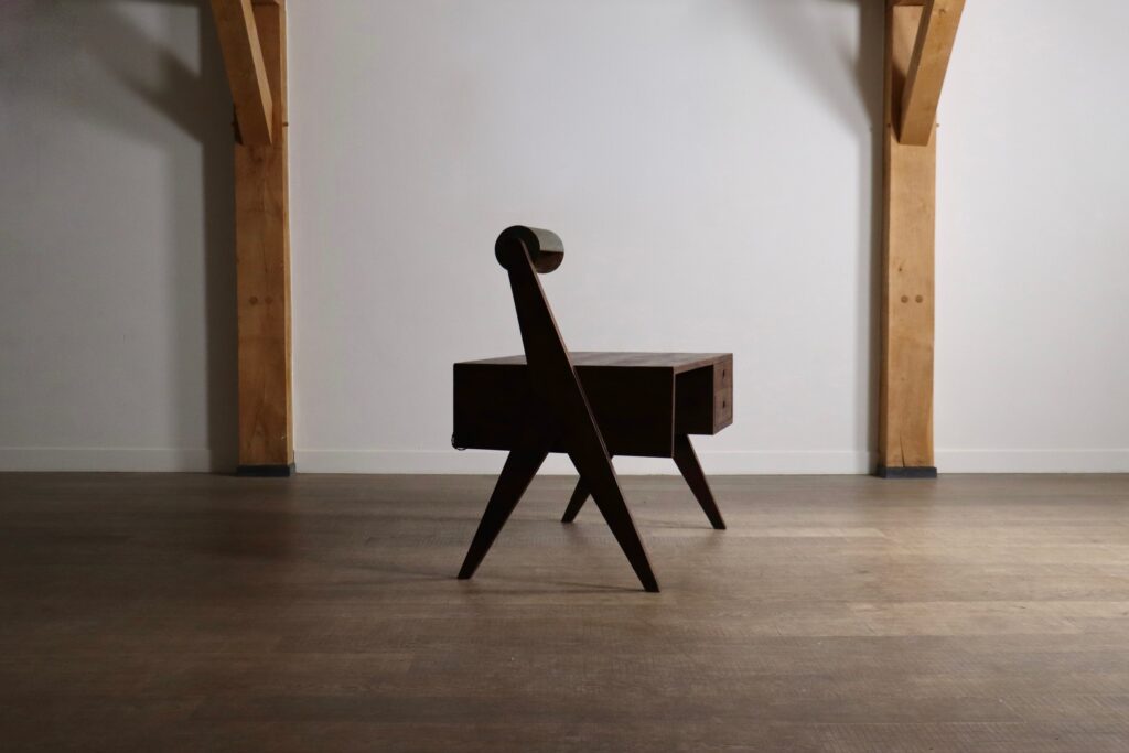 Side view of a Pierre Jeanneret desk with asymmetrical leg construction