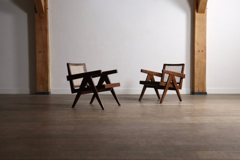 Pair of low Pierre Jeanneret armchairs with teak frames and woven cane panels