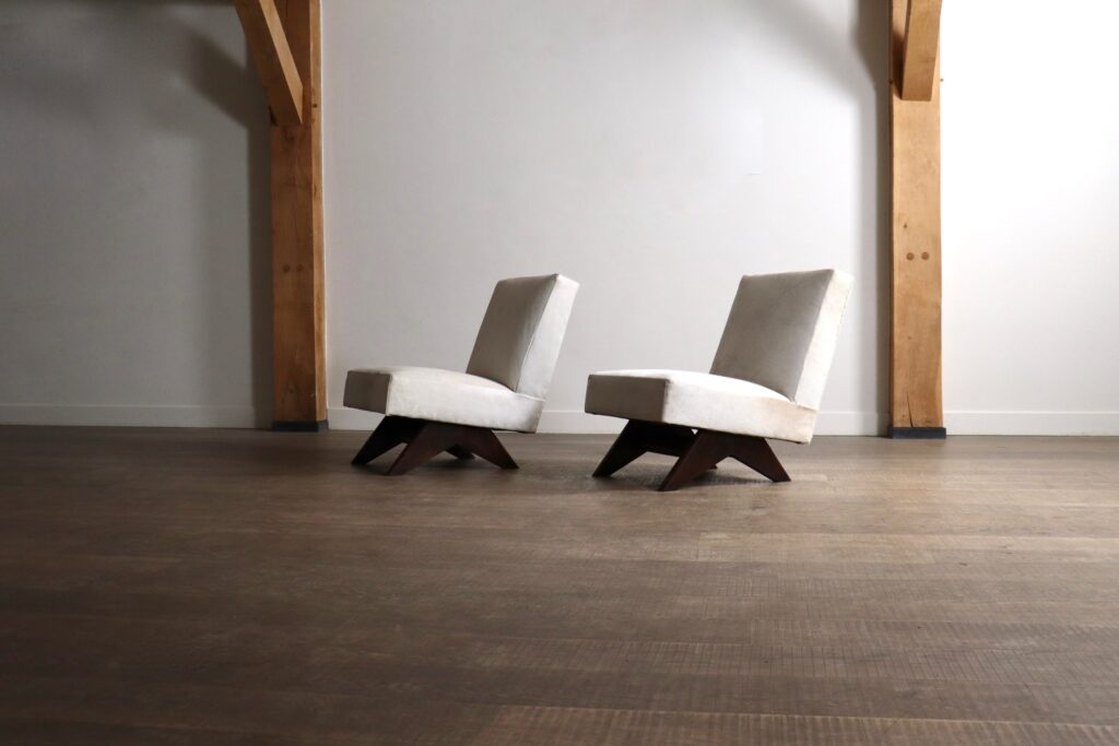 Side view of a Pierre Jeanneret Fireside chair with sculptural teak construction