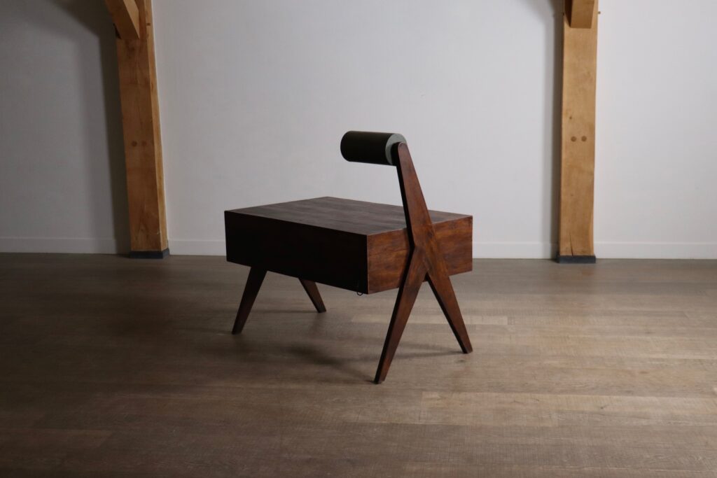 Side view of a Pierre Jeanneret desk with asymmetrical leg construction